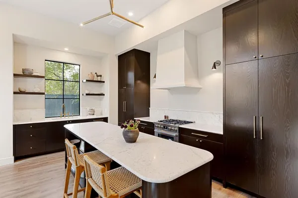 a kitchen with a table chairs and refrigerator