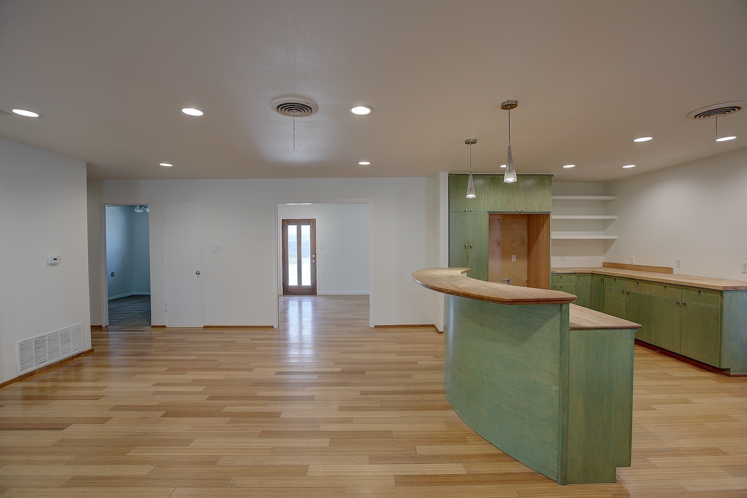1607 South Elm Street Georgetown, TX 78626 - Photo 12 of 40 a view of a kitchen with kitchen island a sink wooden floor and a fireplace