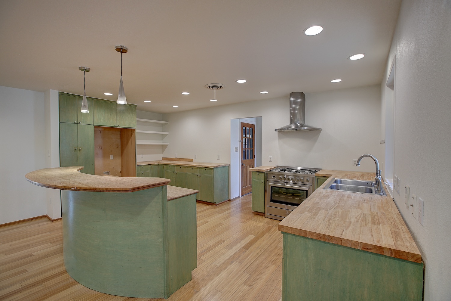 1607 South Elm Street Georgetown, TX 78626 - Photo 13 of 40 a kitchen with kitchen island a counter top space a stove a sink and a refrigerator