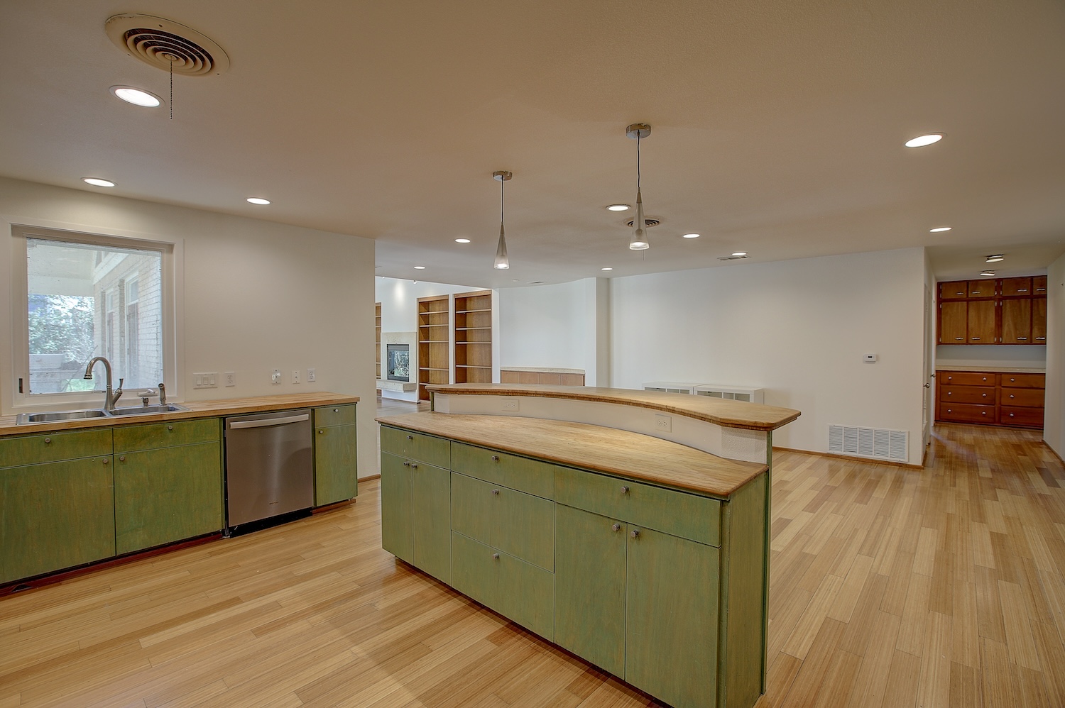 1607 South Elm Street Georgetown, TX 78626 - Photo 15 of 40 a kitchen with kitchen island a sink dishwasher stove and wooden floor