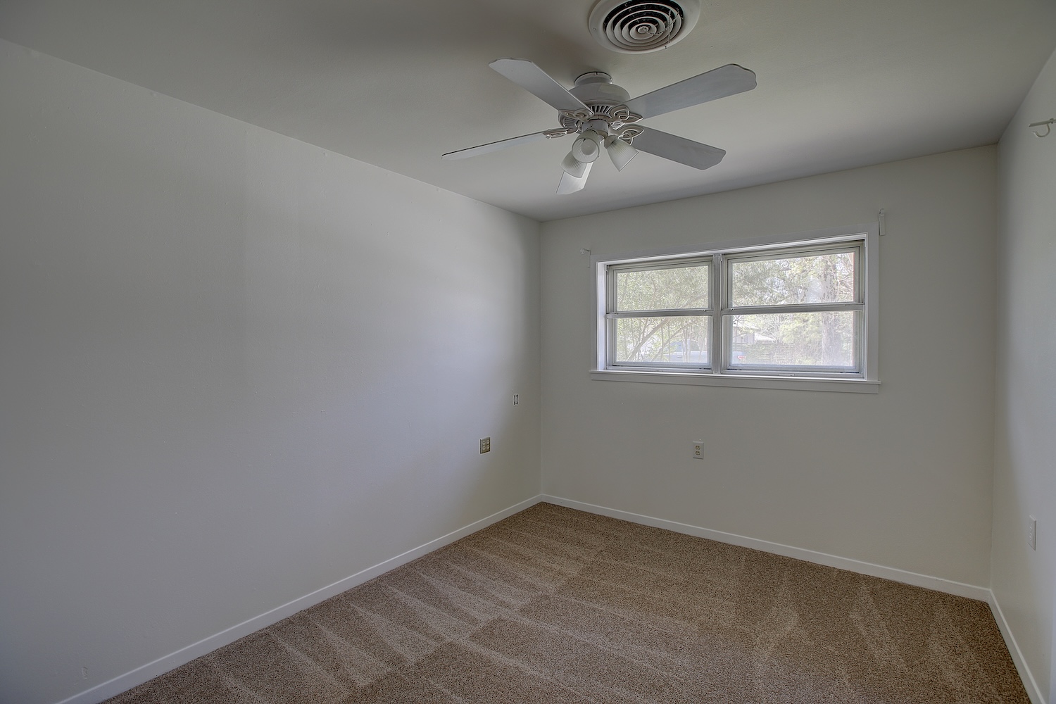 1607 South Elm Street Georgetown, TX 78626 - Photo 35 of 40 an empty room with windows and fan