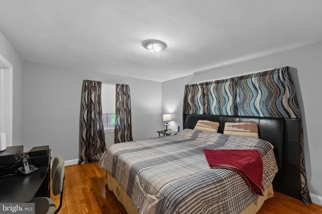 a bedroom with a bed and a mirror