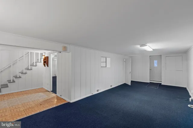 a view of an empty room with a fireplace and a window