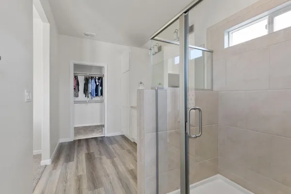 a bathroom with a granite countertop sink toilet mirror and shower