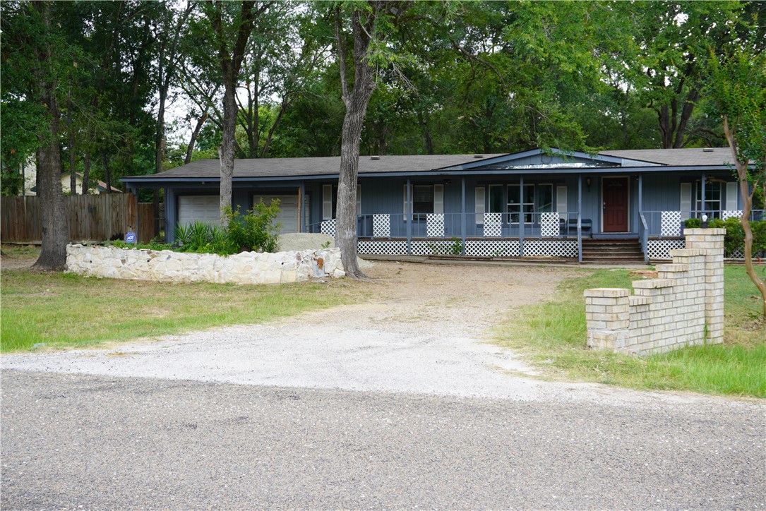 Ranch-style home featuring a garage and a porch