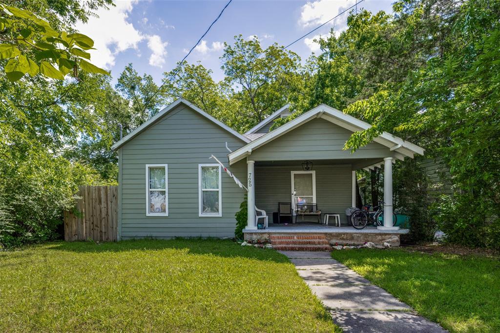 a front view of a house with a garden and yard