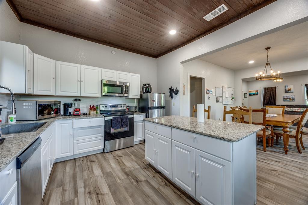 725 South Walnut Street Sherman, TX 75090 - Photo 3 of 10 a kitchen with granite countertop lots of counter top space sink and stainless steel appliances