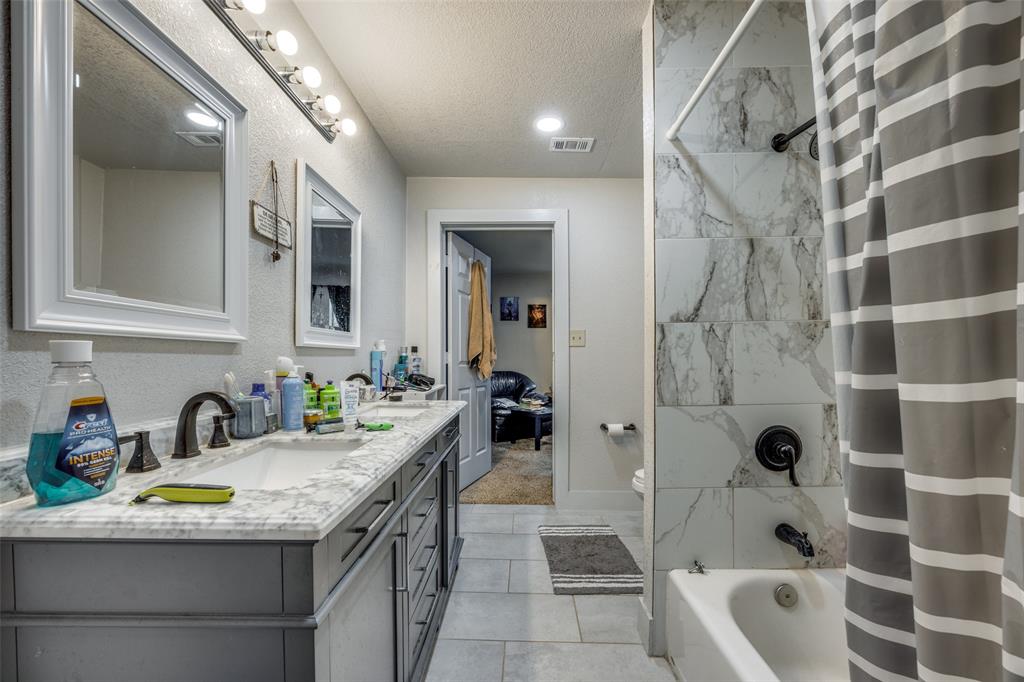 725 South Walnut Street Sherman, TX 75090 - Photo 9 of 10 a bathroom with a granite countertop sink a toilet and shower