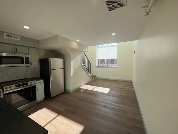 a view of a kitchen with a sink and an oven