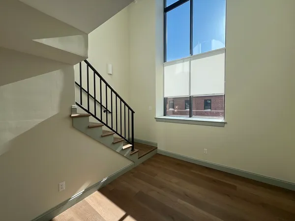 a view of an entryway with wooden floor