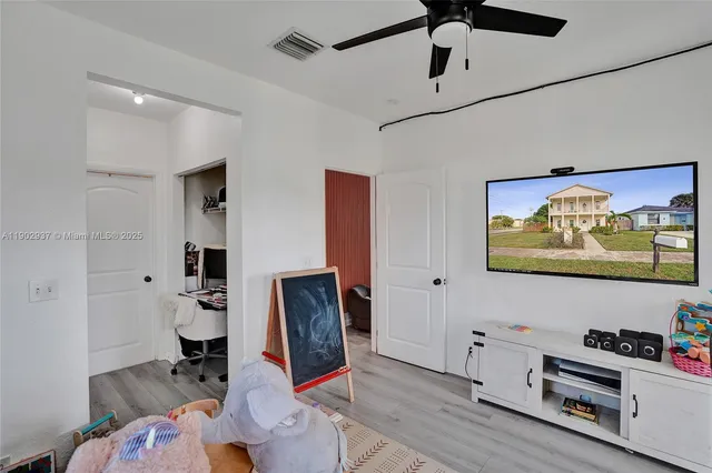 a view of workspace with furniture and ceiling fan