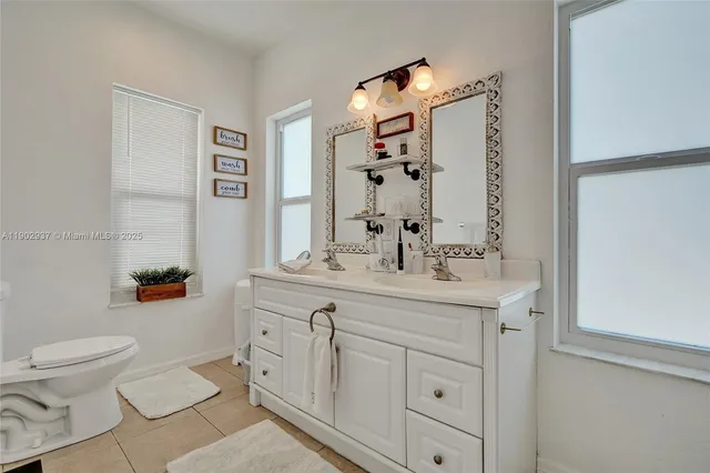 a spacious bathroom with a sink a toilet and shower curtain