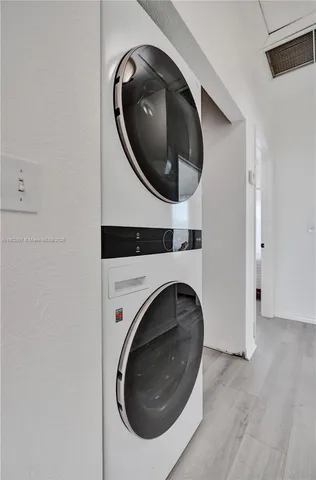a living room with dryer and washer