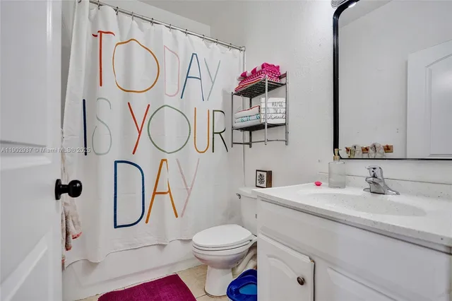 a bathroom with a sink vanity mirror and toilet