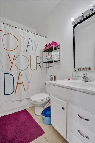 a bathroom with a toilet sink a mirror and shower
