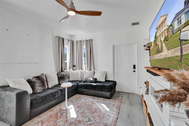 a living room with furniture and a flat screen tv