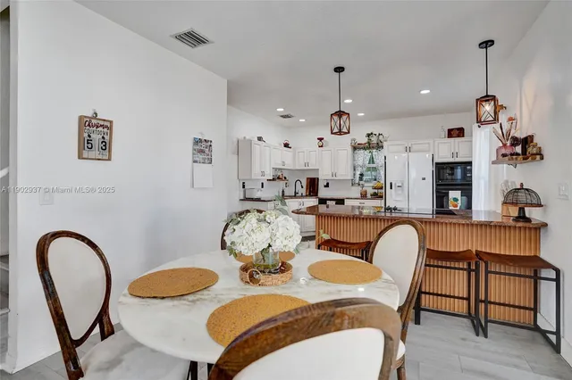 a dining room with furniture and wooden floor