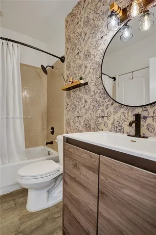 a bathroom with a sink toilet and shower