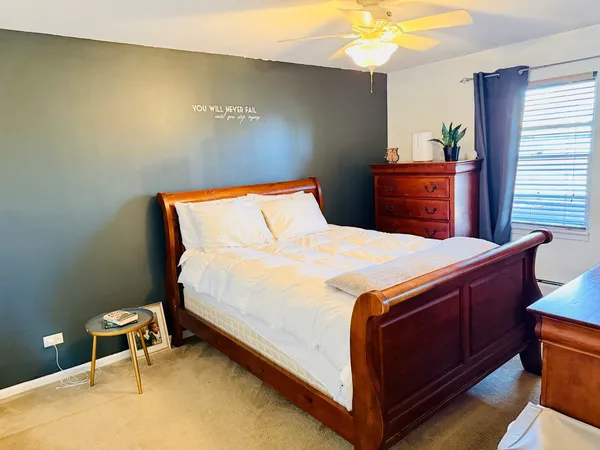 a bedroom with a bed and a chandelier
