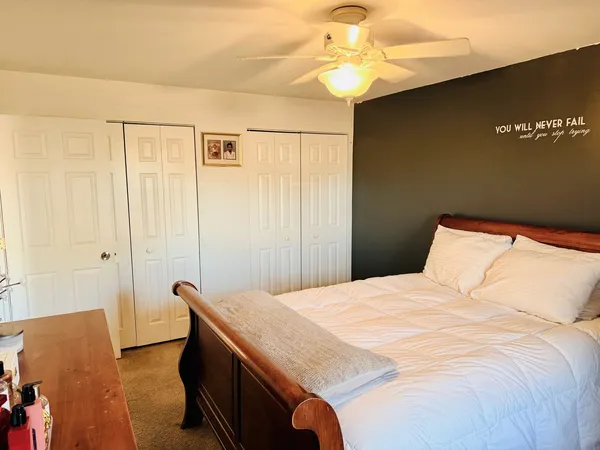 a bedroom with a bed and a chandelier