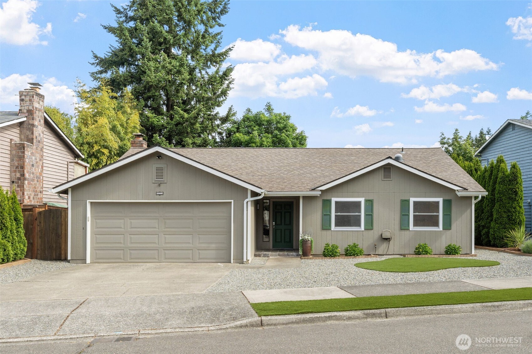 a front view of a house with a yard and garage