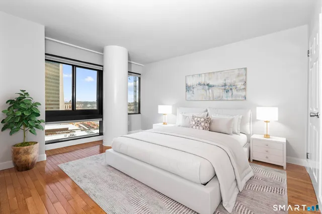 a bedroom with a large bed and a large window