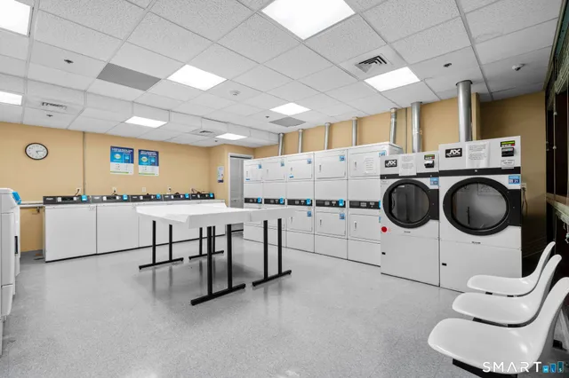 a kitchen with stainless steel appliances a refrigerator a sink a stove a microwave and cabinets