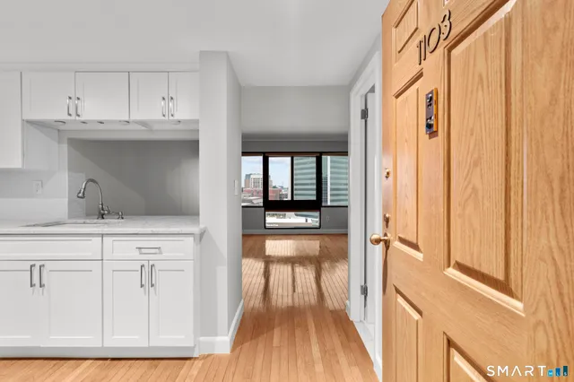 a kitchen with cabinets and wooden floor