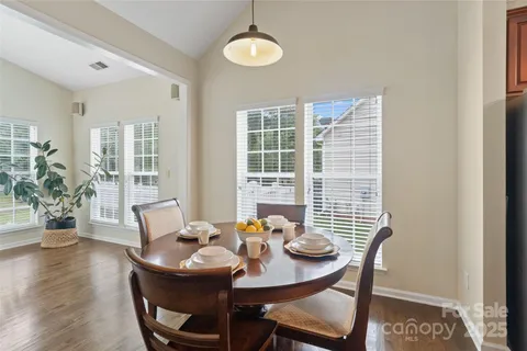 a living room with furniture floor to ceiling window and wooden floor