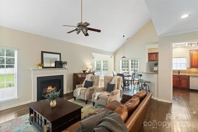 a living room with furniture a fireplace and a flat screen tv