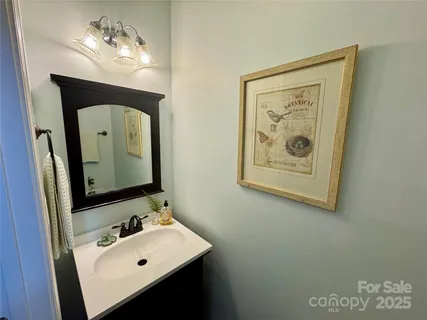 a bedroom with a bed lamps and wooden floor