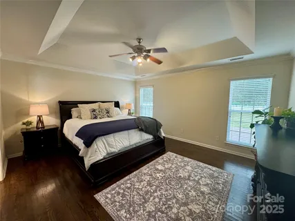 a bedroom with a bed dresser and a window