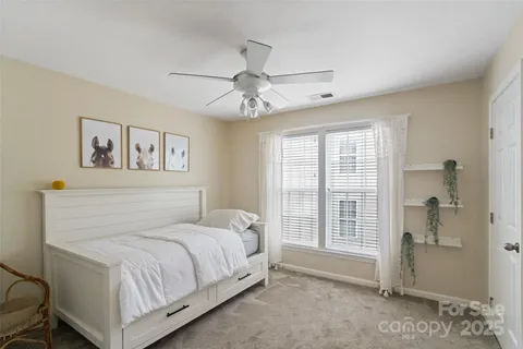 a view of a livingroom with a chandelier fan