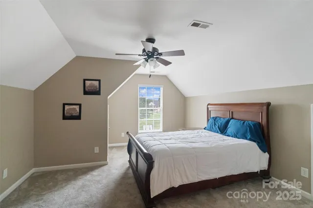 a bedroom with a bed and a ceiling fan