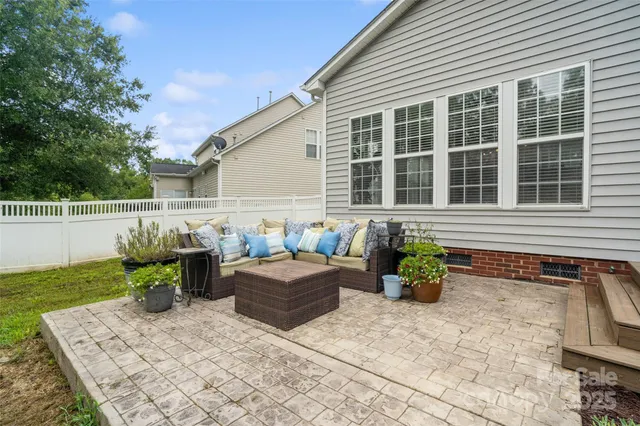 a front view of a house with outdoor seating