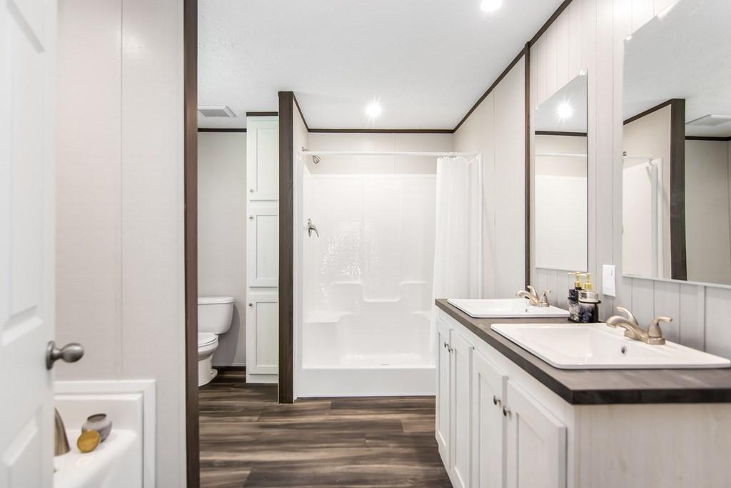 152 Wendy Hill Road Ellijay, GA 30536 - Photo 25 of 42 a bathroom with a sink and a mirror with bathtub