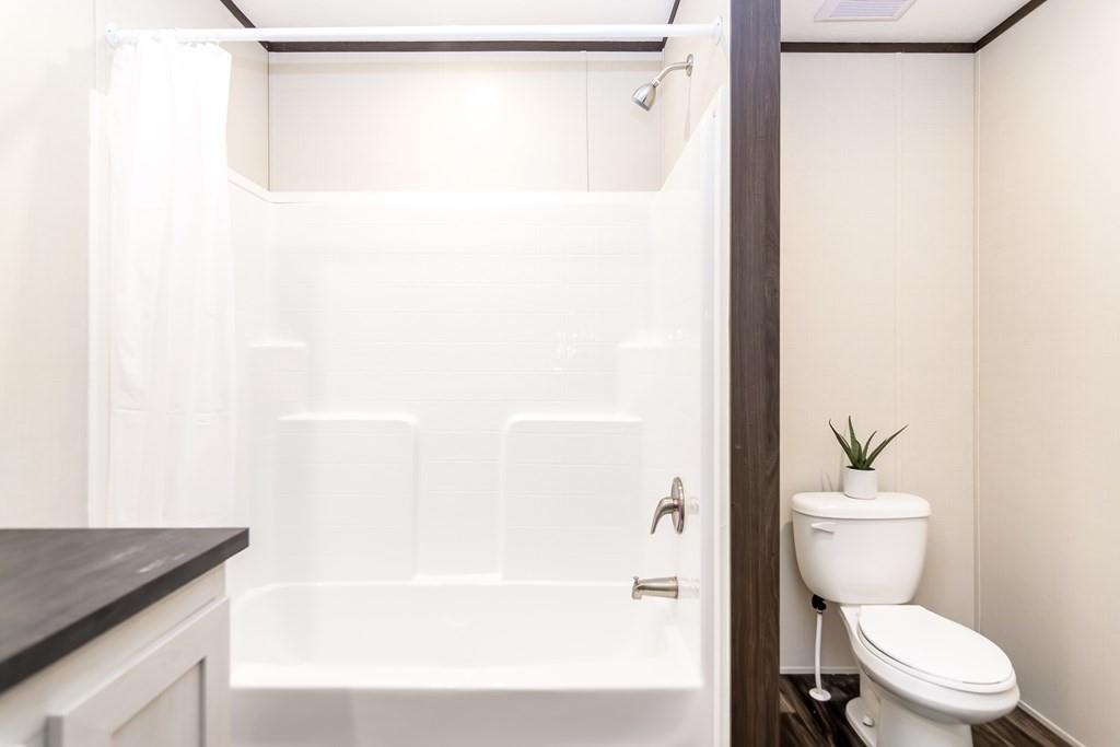 152 Wendy Hill Road Ellijay, GA 30536 - Photo 31 of 42 a white toilet sitting next to a bathroom sink