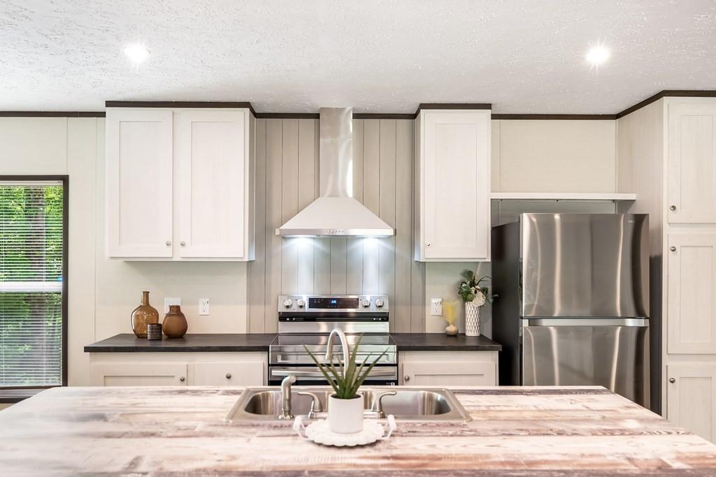 152 Wendy Hill Road Ellijay, GA 30536 - Photo 9 of 42 a kitchen with stainless steel appliances kitchen island granite countertop a refrigerator and a stove top oven