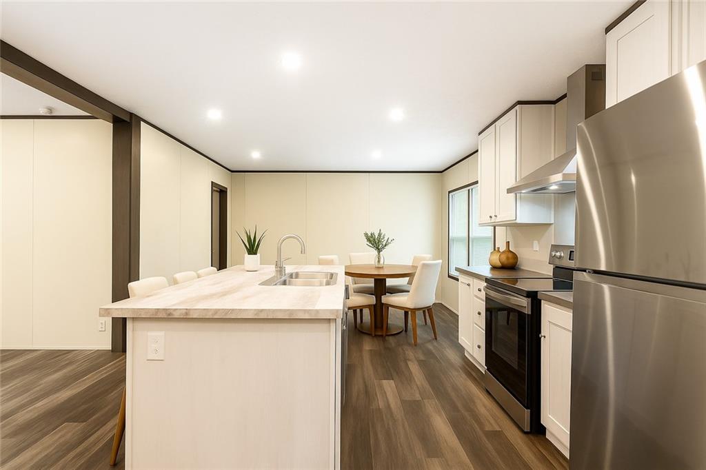 152 Wendy Hill Road Ellijay, GA 30536 - Photo 10 of 42 a kitchen with stainless steel appliances granite countertop a refrigerator a stove a sink dishwasher and a refrigerator with wooden floor