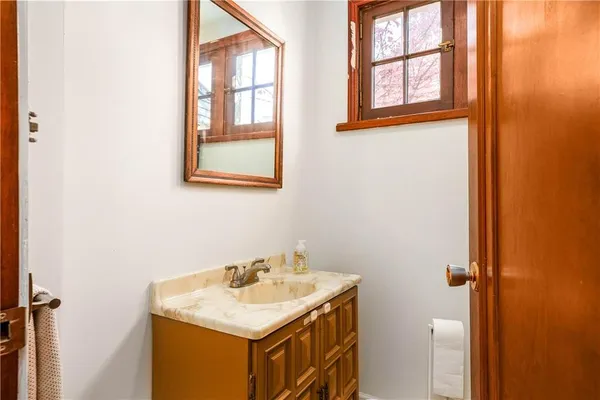 a bathroom with a sink and a window