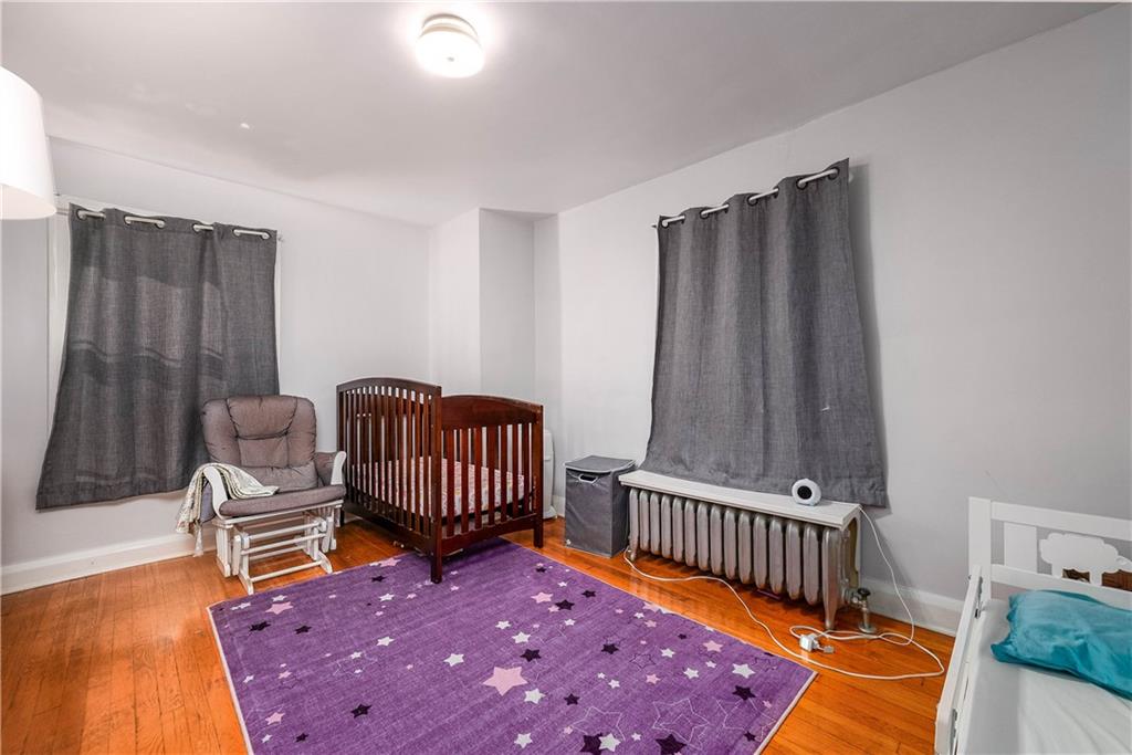 853 Collins Street Pittsburgh, PA 15206 - Photo 17 of 31 a bedroom with furniture and a rug