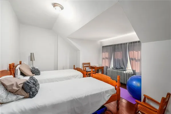 a bedroom with bed and a chair