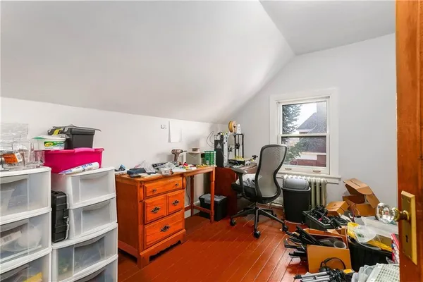 a view of a workspace with furniture and a window