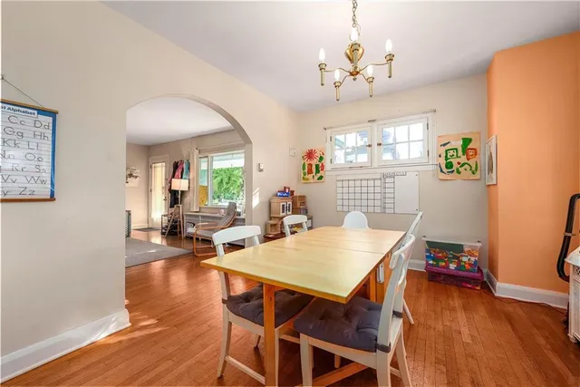 a view of a dining room with furniture wooden floor and chandelier