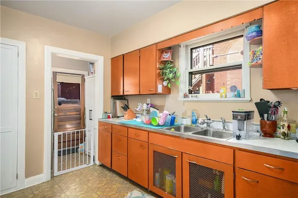 a kitchen with stainless steel appliances lots of counter top space and a window