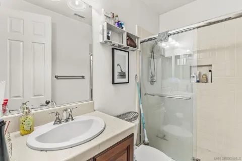 a bathroom with a sink toilet and shower
