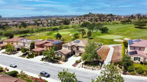 an aerial view of residential houses with outdoor space and river