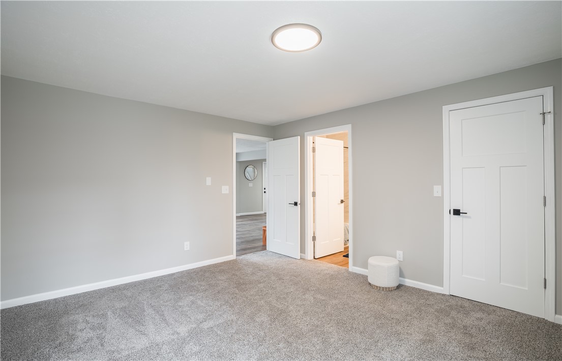 8240 Looney Road Piqua, OH 45356 - Photo 19 of 49 This spacious bedroom offers ample natural light and a serene ambiance, perfect for relaxation.