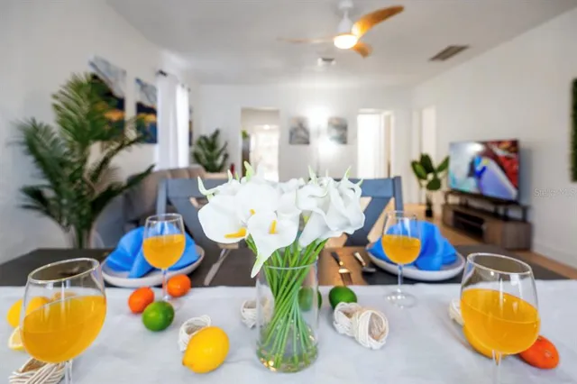 a dining room with furniture and a mirror