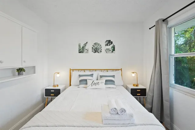 a bedroom with a bed and a window